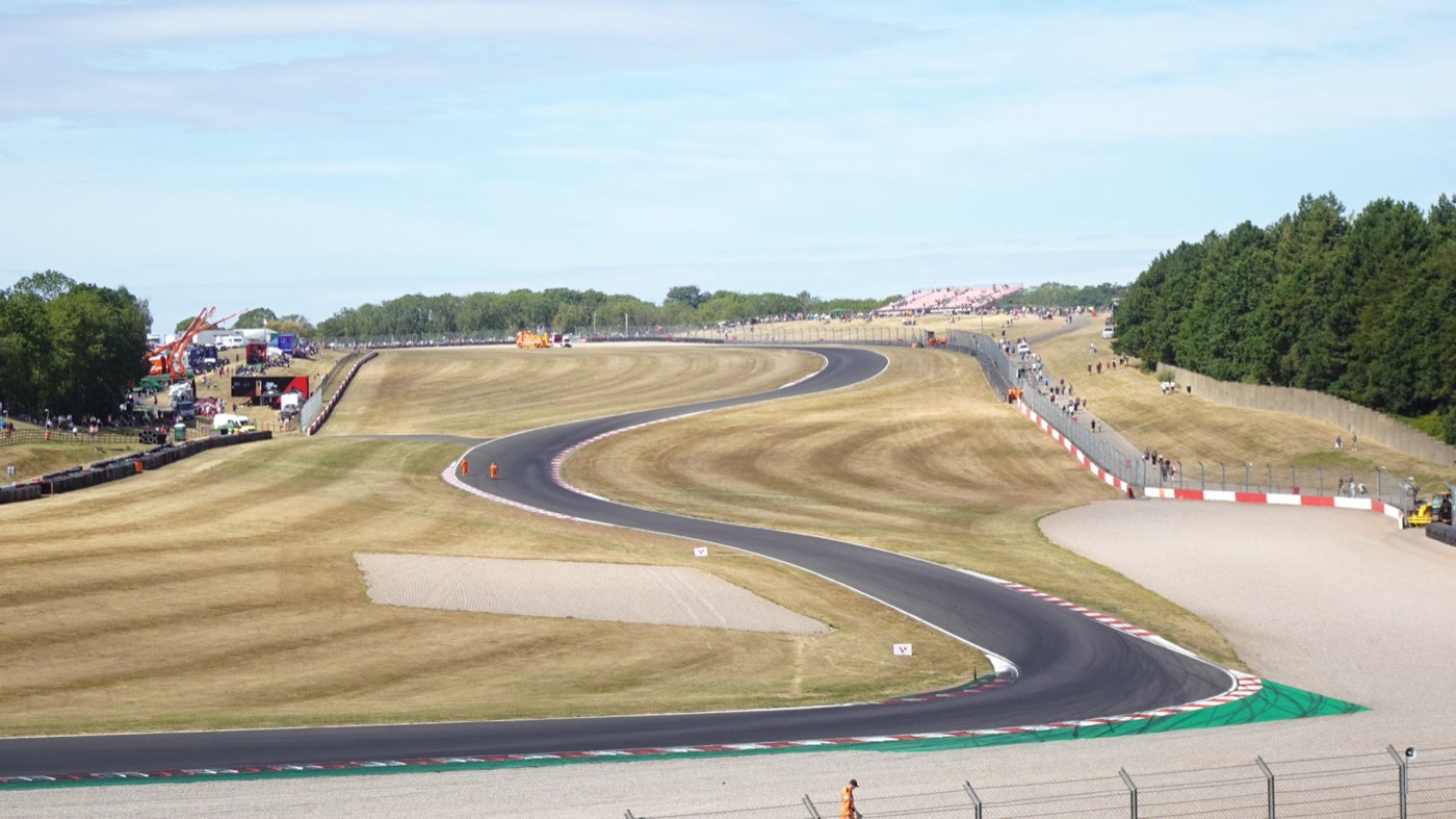 The Craner Curves at Donington Park, an S-bend of track rising up a grass hillside towards Old Hairpin, seen from the bottom of the hill