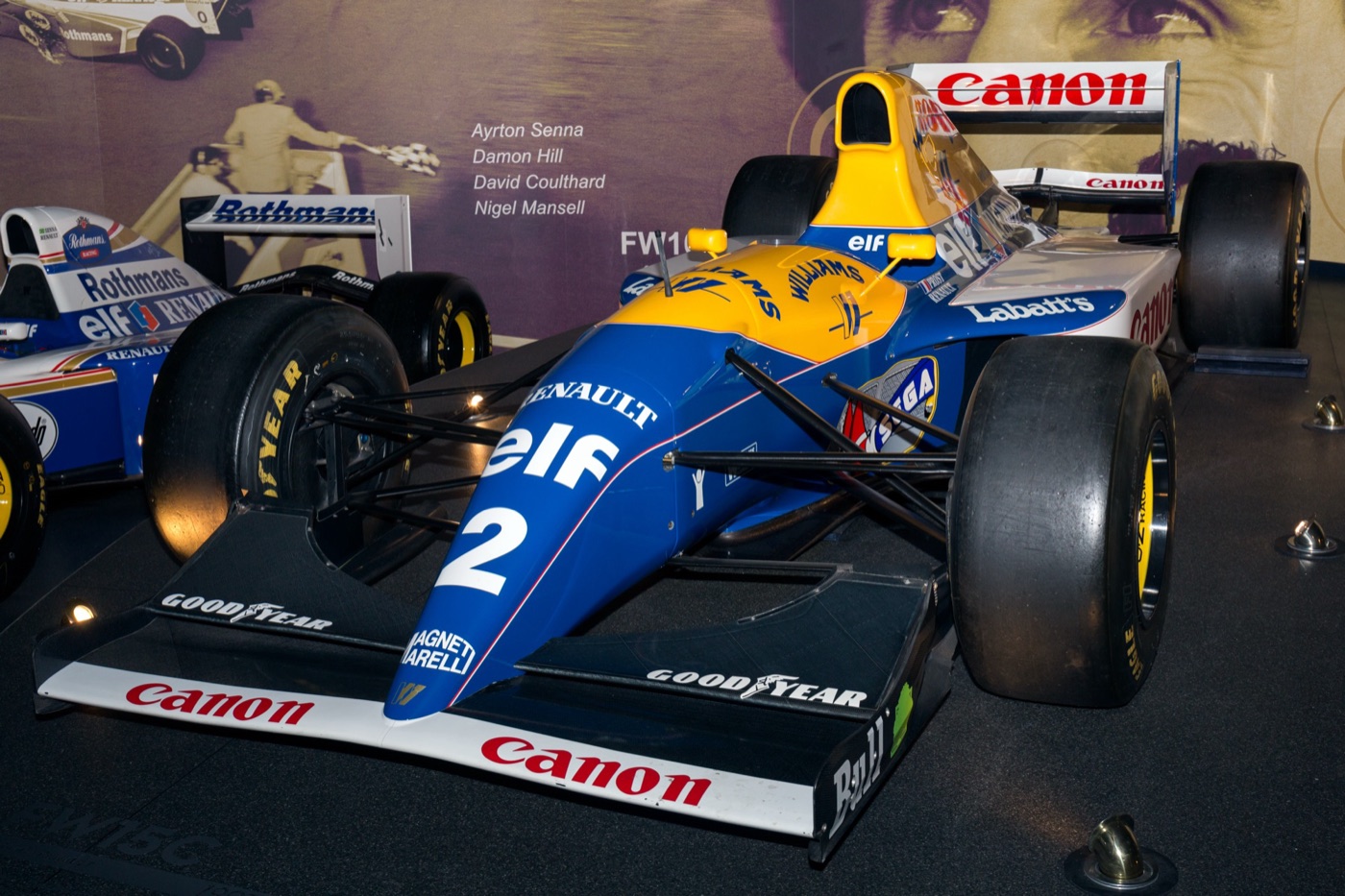 Blue, yellow and white Williams FW15C Formula One car number 2 with Renault, Elf, Canon and Sega logos on display indoors