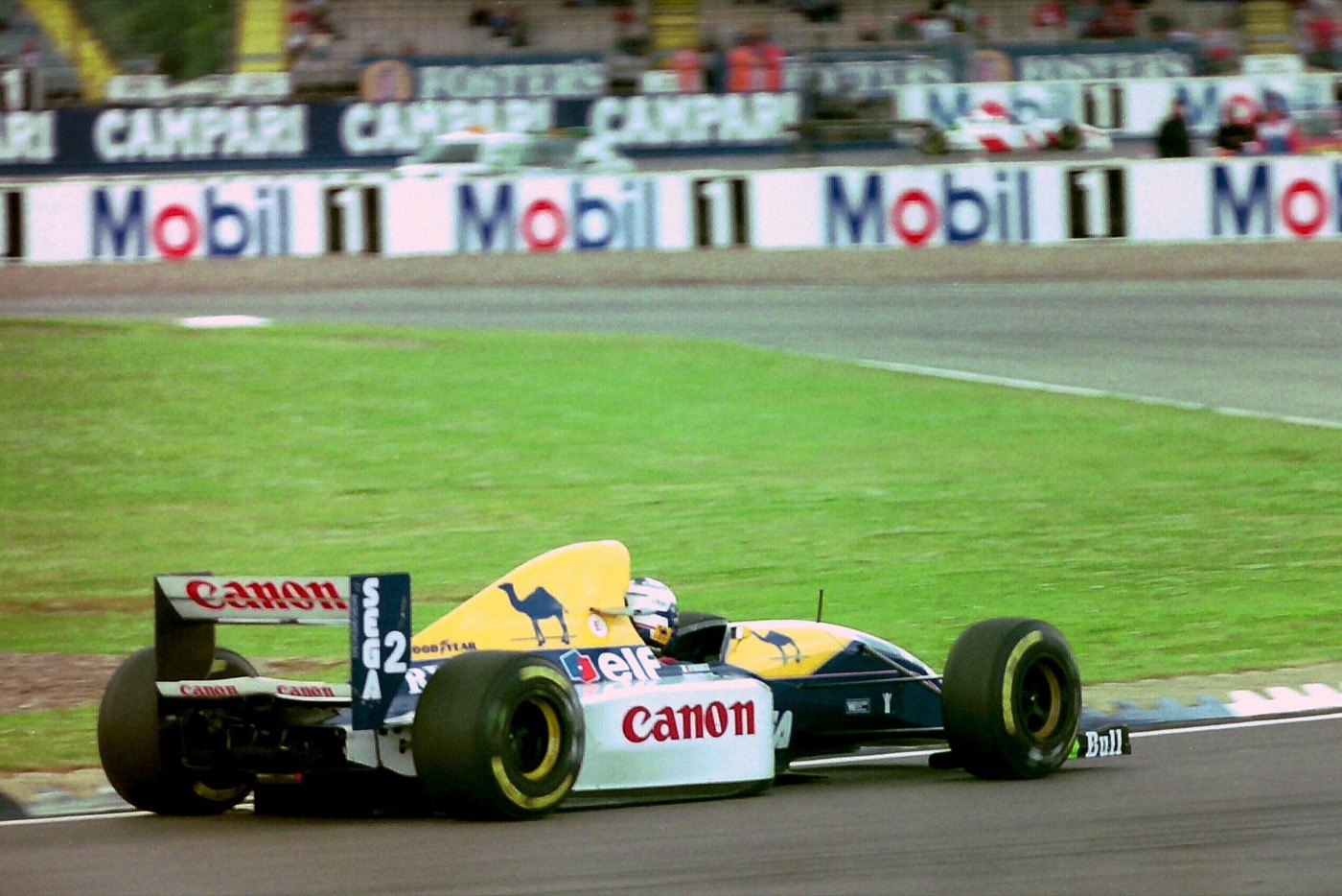Prost’s blue, white and yellow Williams FW15C, number 2, with Canon, Camel and Elf logos, on track at Silverstone