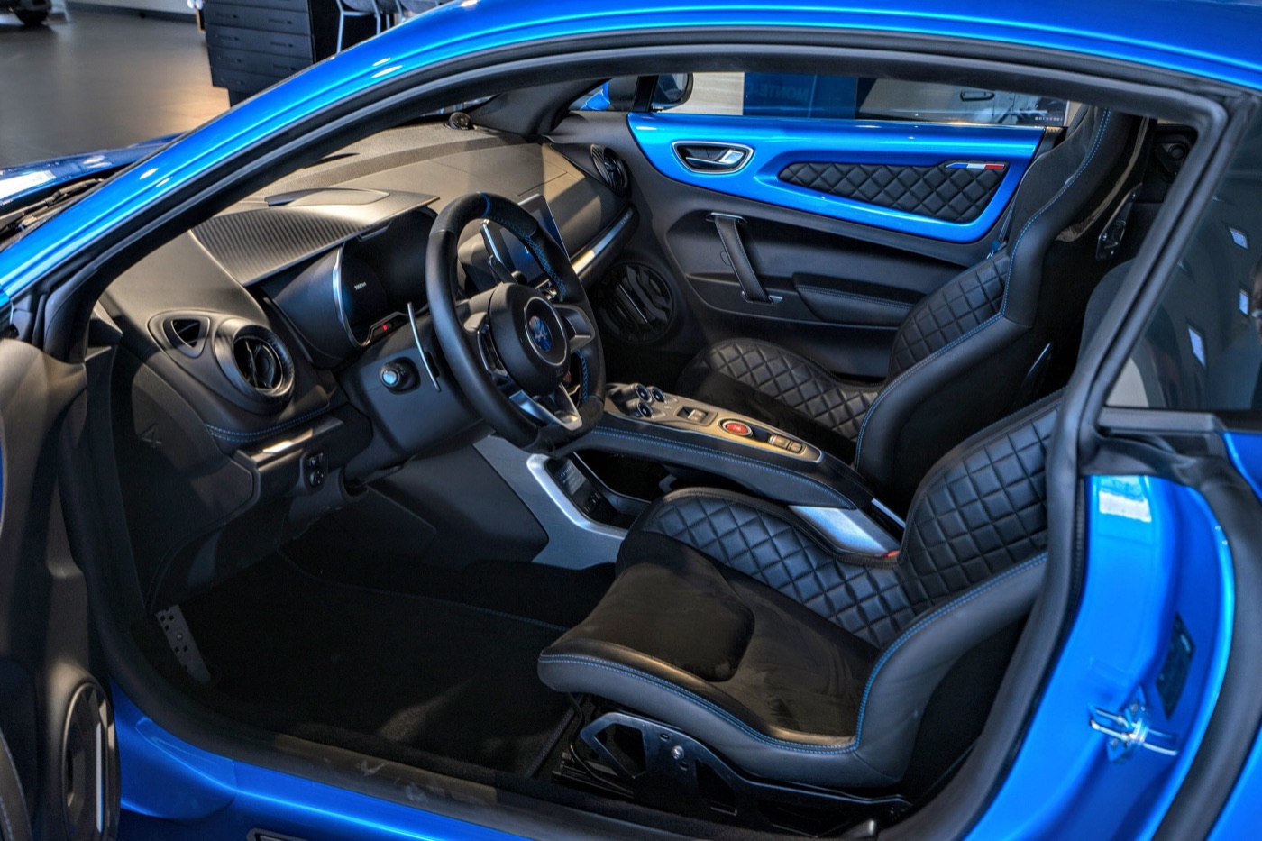 Interior of a 2018 Alpine A110 with quilted Sabelt bucket seats and a floating centre console