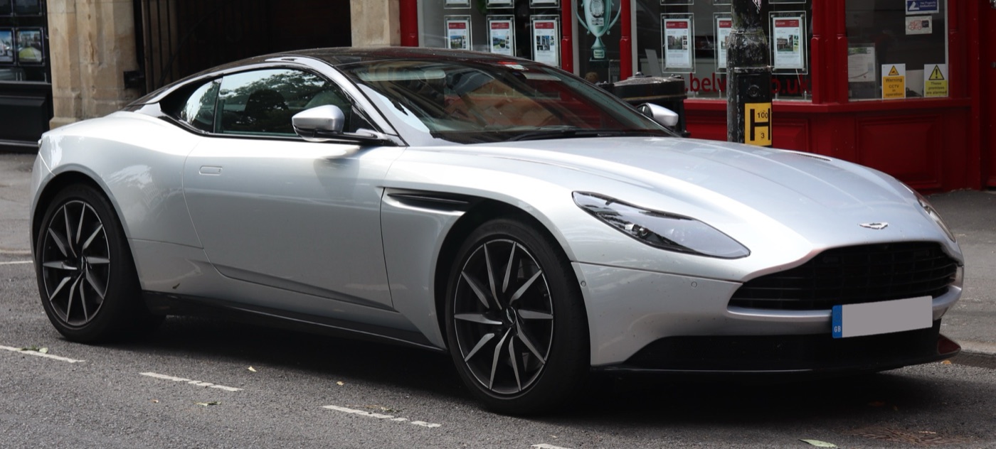 Silver Aston Martin DB11 V8 coupé parked on a town street