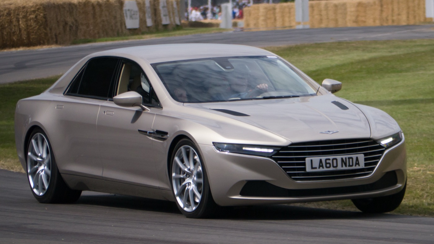 Champagne-coloured Lagonda Taraf four-door saloon driving past straw bales