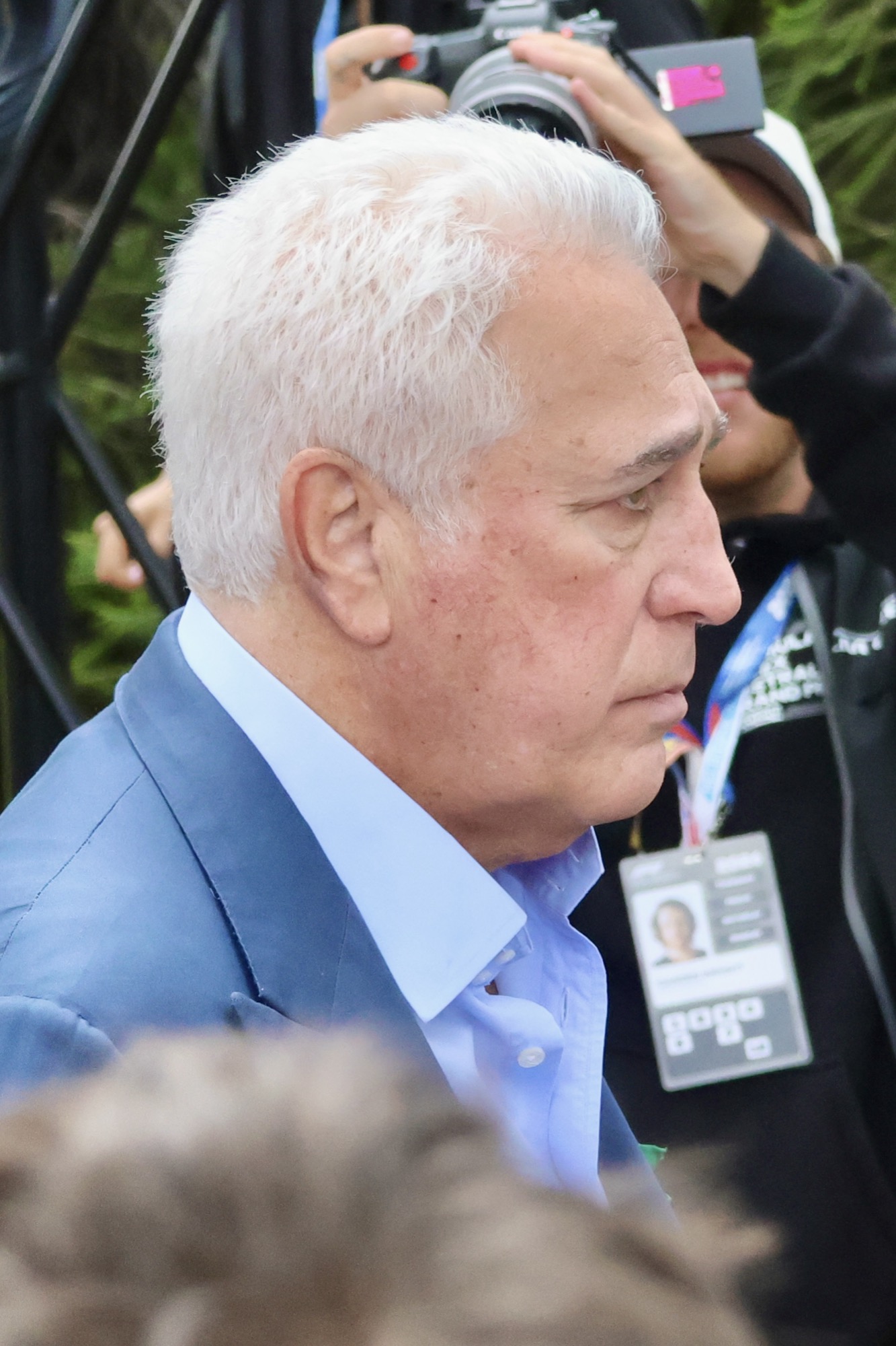 Lawrence Stroll, white-haired, in a blue jacket, in profile in a crowd at the Australian Grand Prix