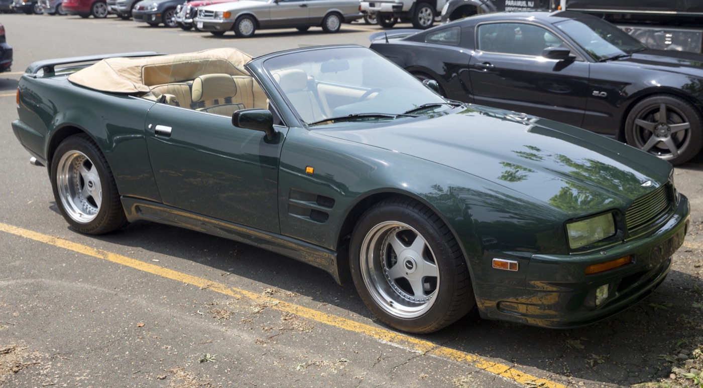 Green 1993 Aston Martin Virage Volante Widebody with its tan hood folded and five-spoke alloy wheels