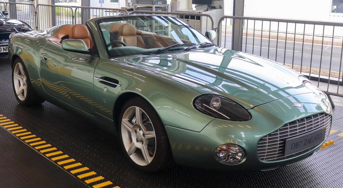 Green Aston Martin DB AR1 roadster with no roof, a tan leather interior and a slatted grille, on display at Gaydon