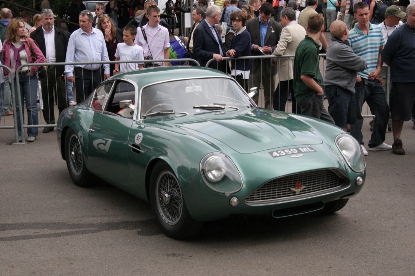 Green Aston Martin DB4 GT Zagato with wire wheels and an oval grille, registration 4359 ML, in the paddock at Goodwood