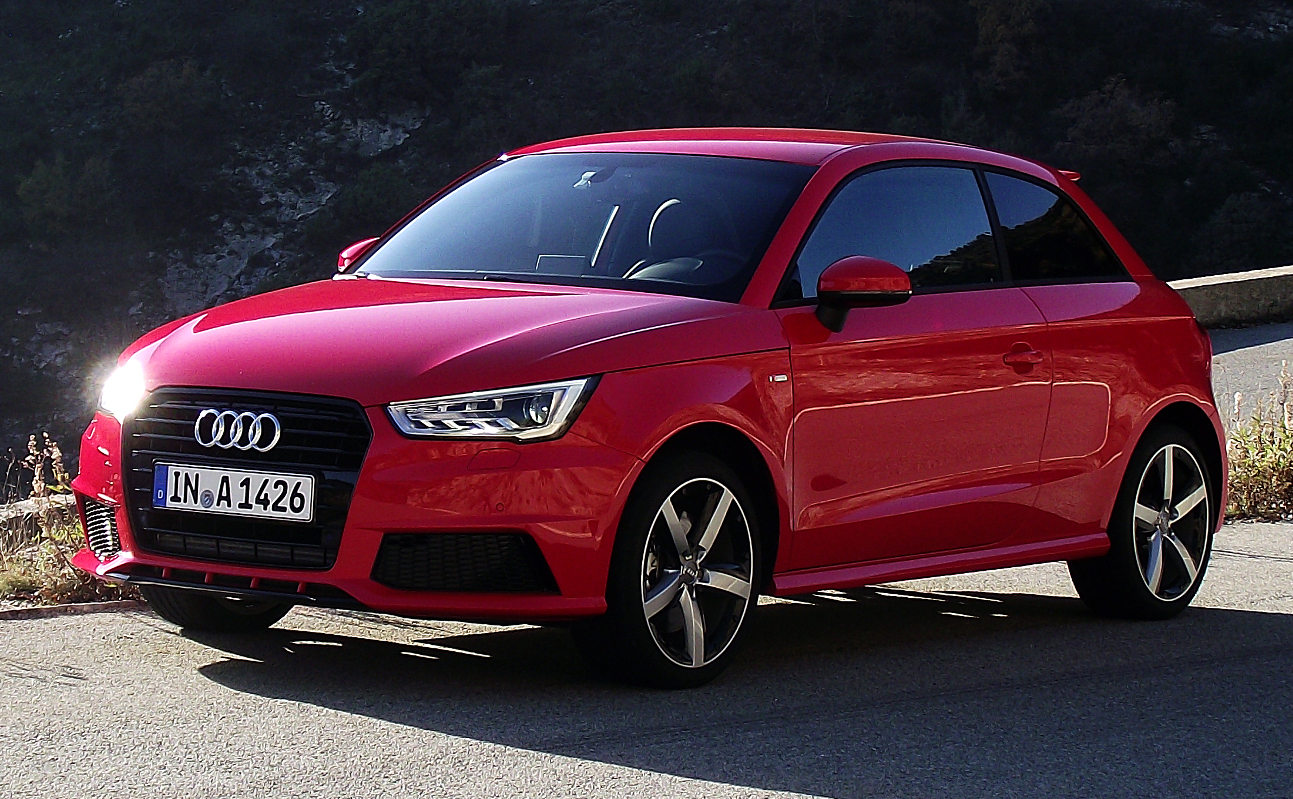 Red facelifted Audi A1 three-door with sharper headlamps parked on a mountain road