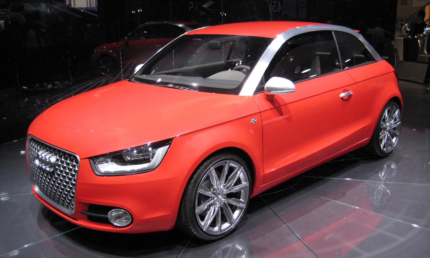 Red Audi metroproject quattro concept car with a silver roof arch on a motor show stand