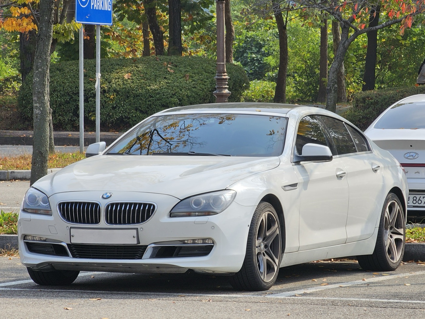 White BMW 640d Gran Coupé xDrive M Sport in a car park, front three-quarter view