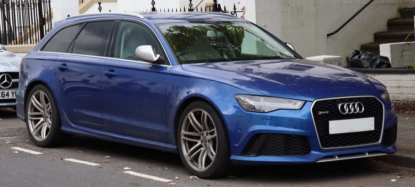 Blue facelifted Audi RS6 C7 Avant with a honeycomb grille and silver twin-spoke wheels, parked in a street, front three-quarter view