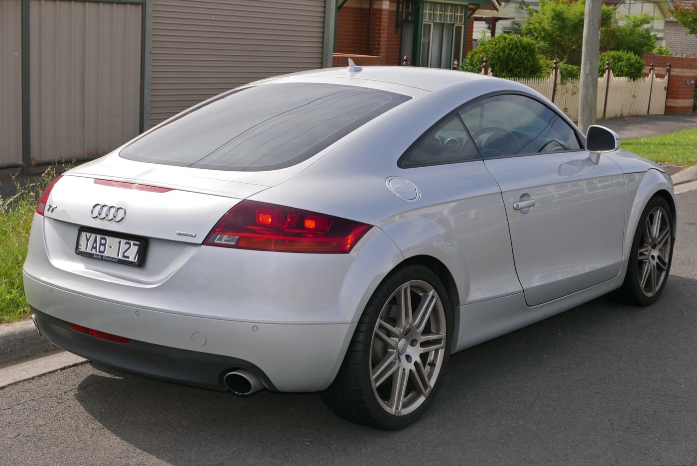Rear three-quarter view of a silver Audi TT 3.2 quattro coupe with twin exhausts