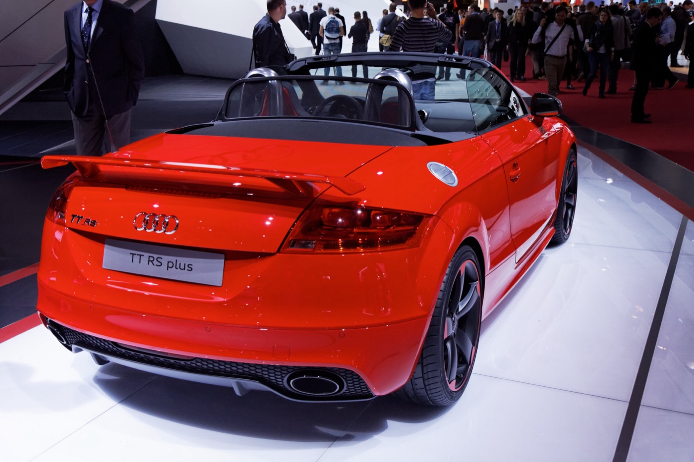 Red Audi TT RS plus Roadster with a fixed rear wing and TT RS plus plate on a show stand