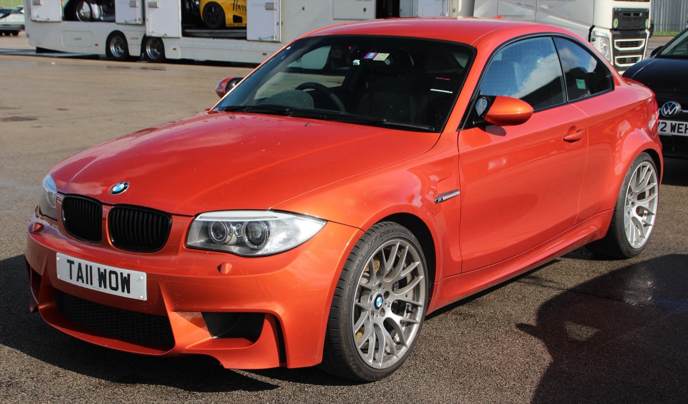 Valencia Orange BMW 1M Coupe with silver Y-spoke wheels in the paddock at Donington Park