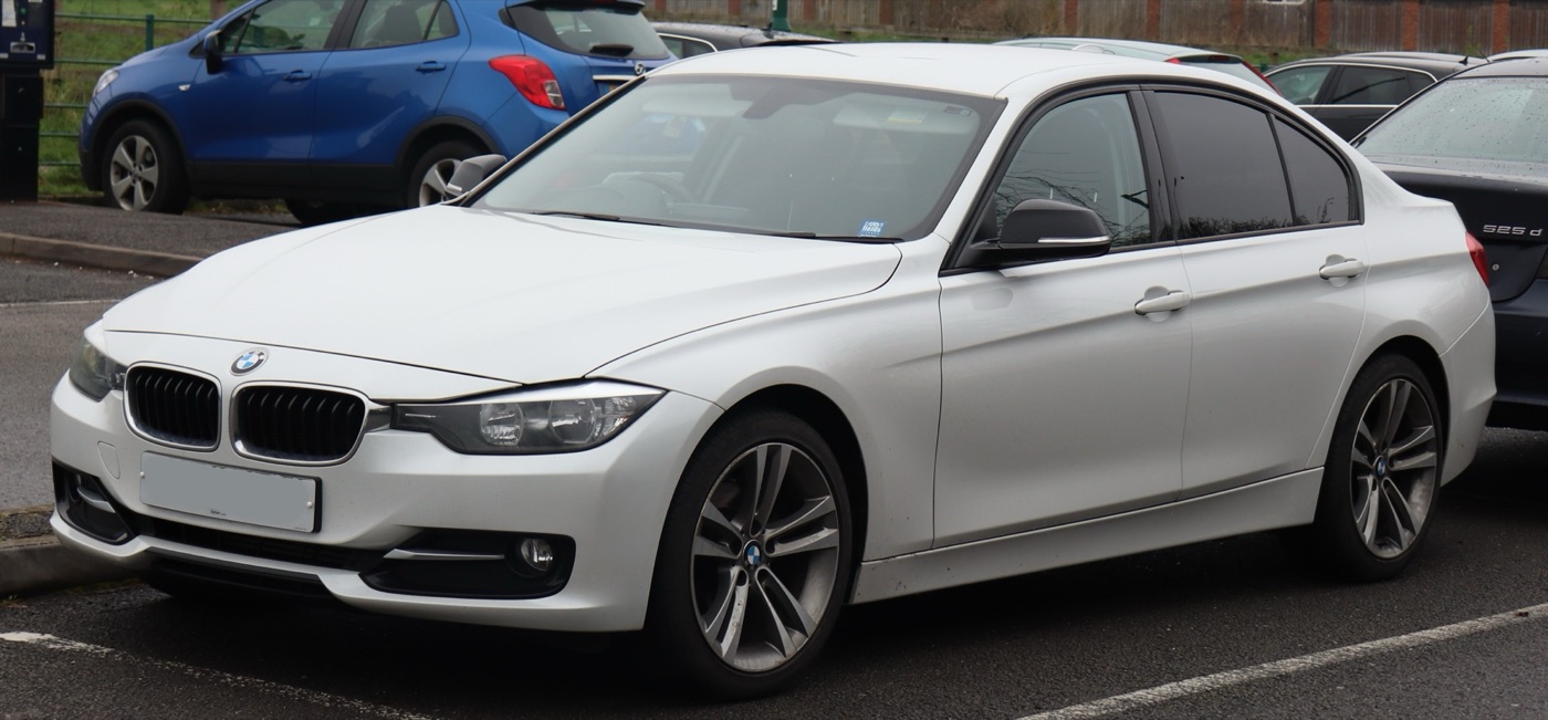 White 2012 BMW 318d Sport F30 saloon in a car park, seen from the front three-quarter