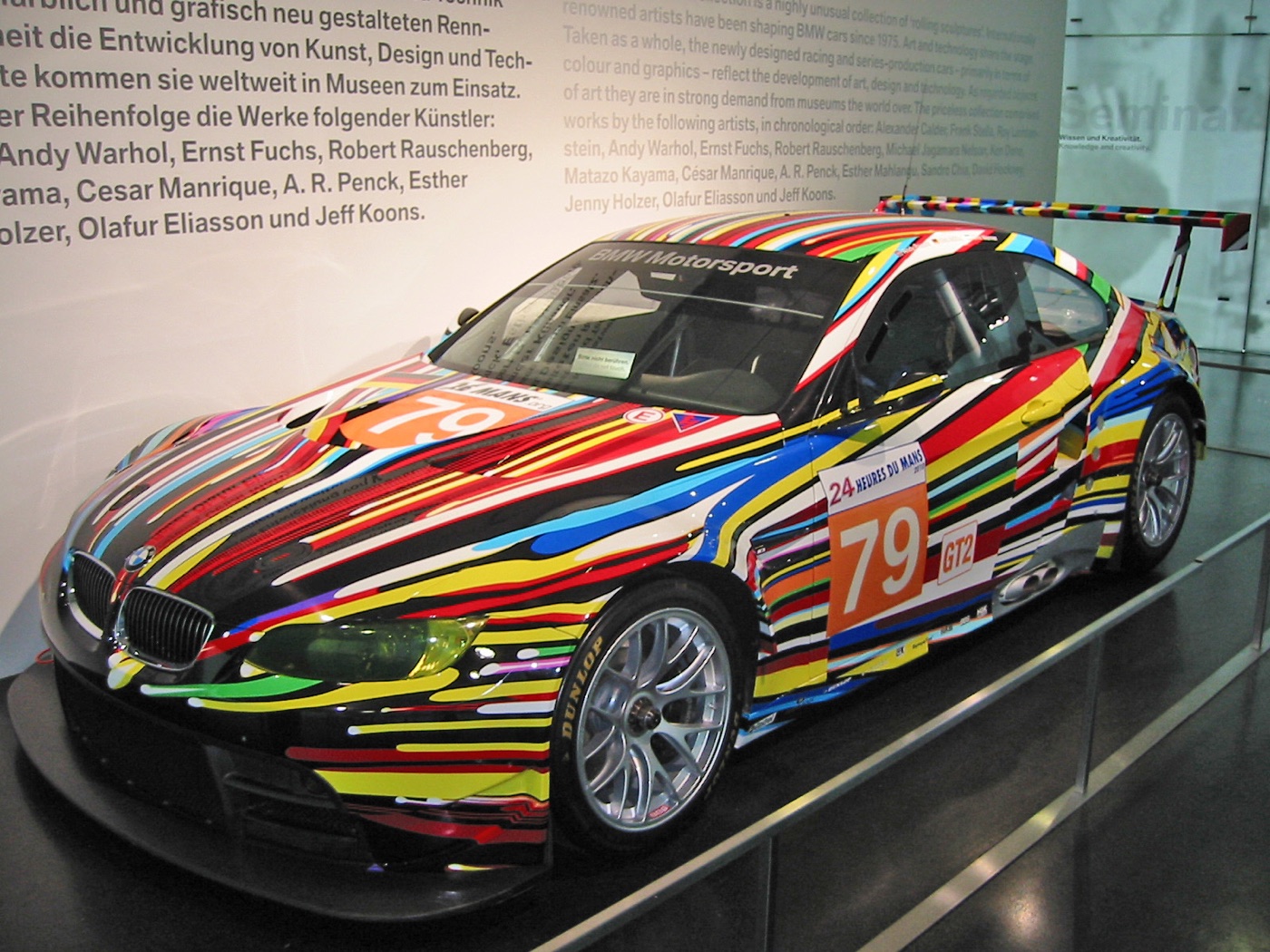 Jeff Koons’s BMW M3 GT2 Art Car with bright streaks of colour on black, race number 79 and 24 Heures du Mans stickers, in the BMW Museum