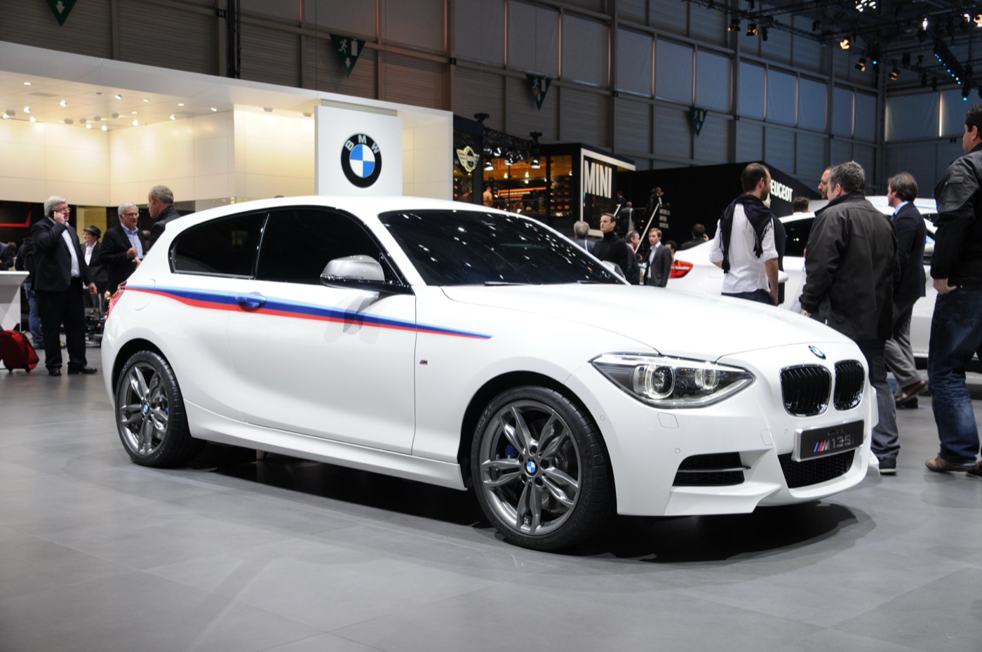 White BMW Concept M135i three-door with blue, violet and red M stripes on the BMW stand at the Geneva motor show