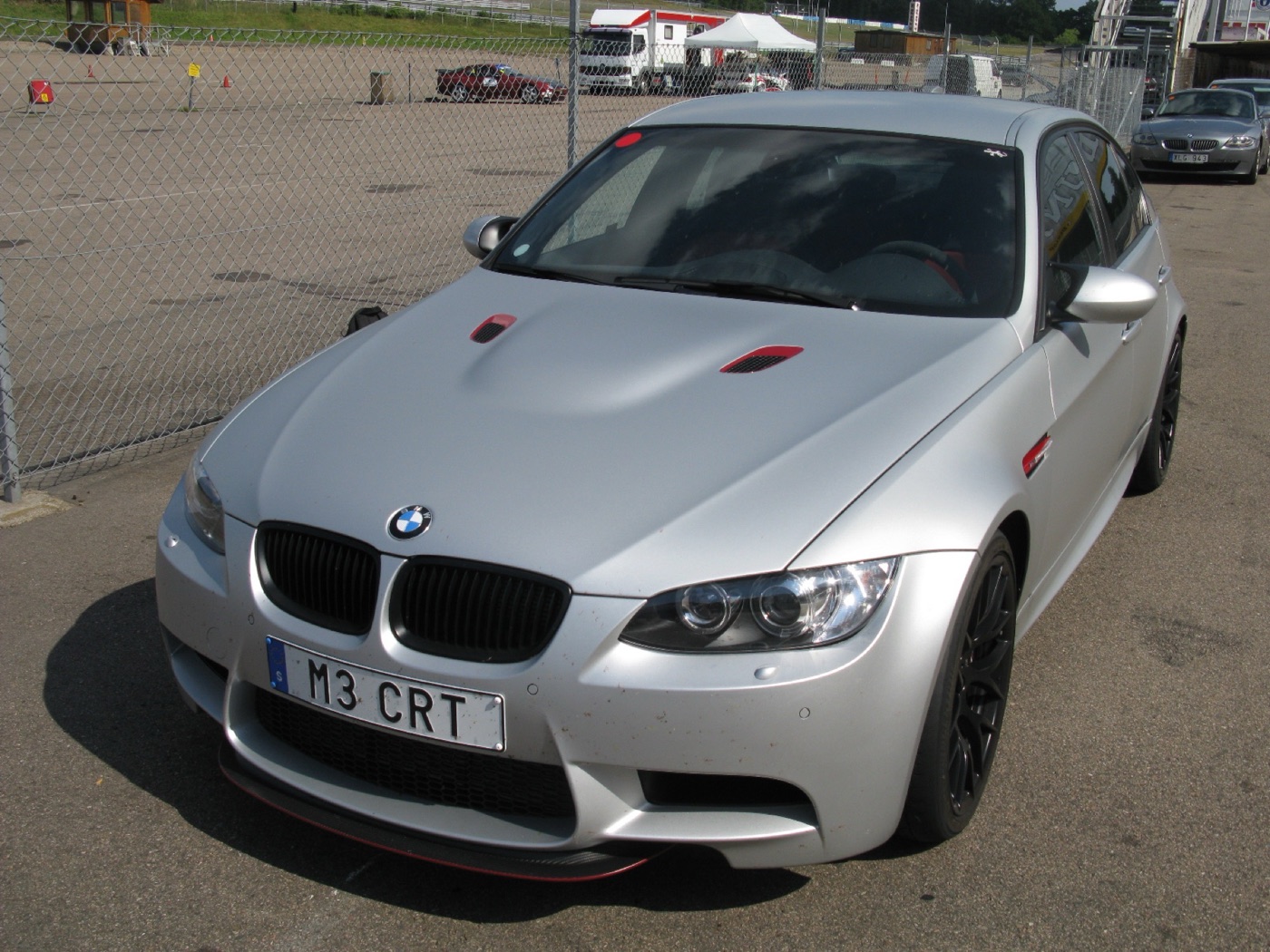 Matt silver BMW M3 CRT saloon from the front with an M3 CRT number plate and red accents on the bonnet vent