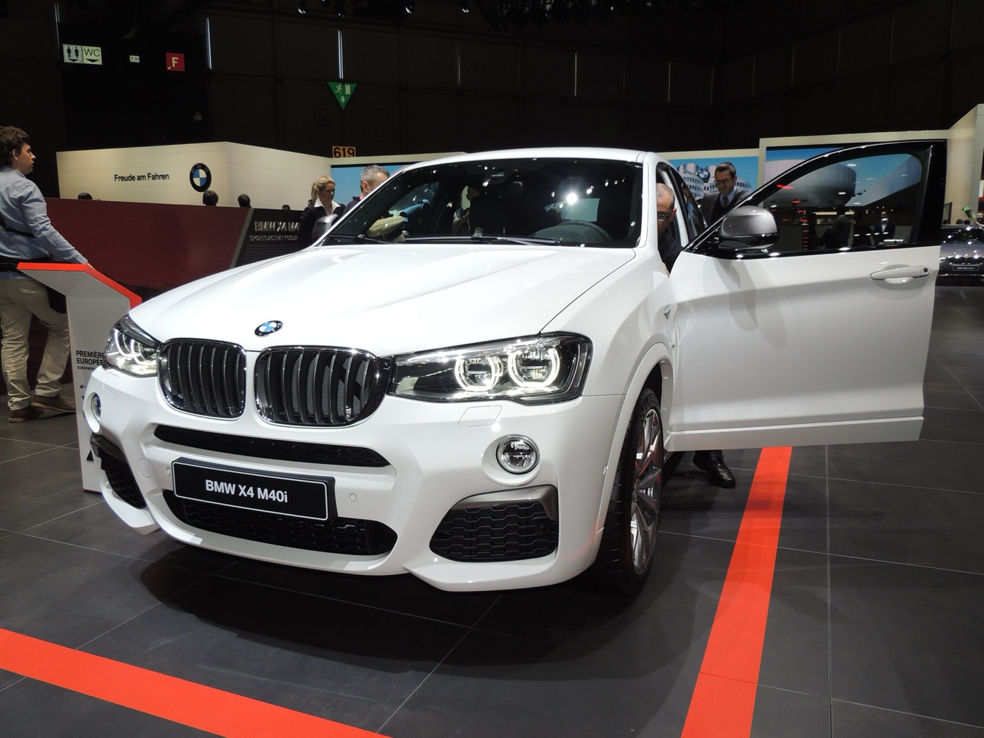 White BMW X4 M40i with its driver