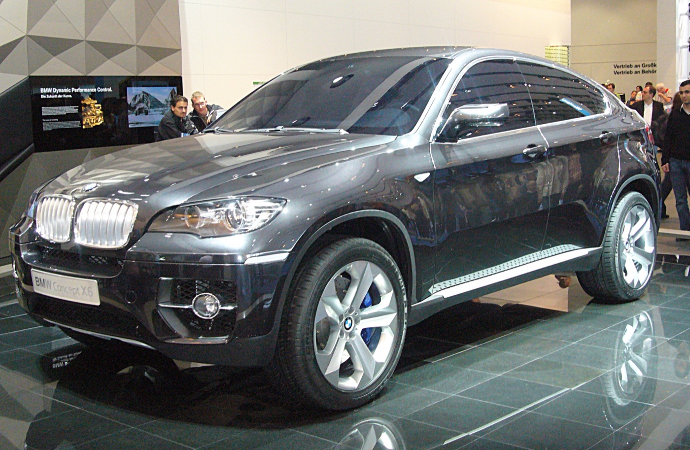 Dark grey BMW Concept X6 on the BMW stand at the Frankfurt motor show, a Dynamic Performance Control display behind it