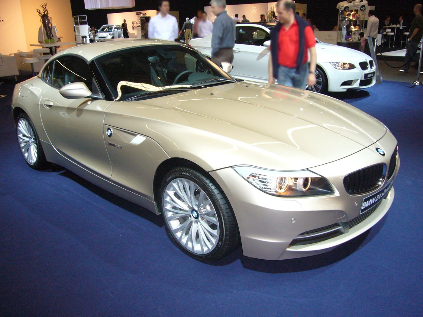 Champagne-coloured BMW Z4 sDrive30i with its hard top closed on a motor show stand