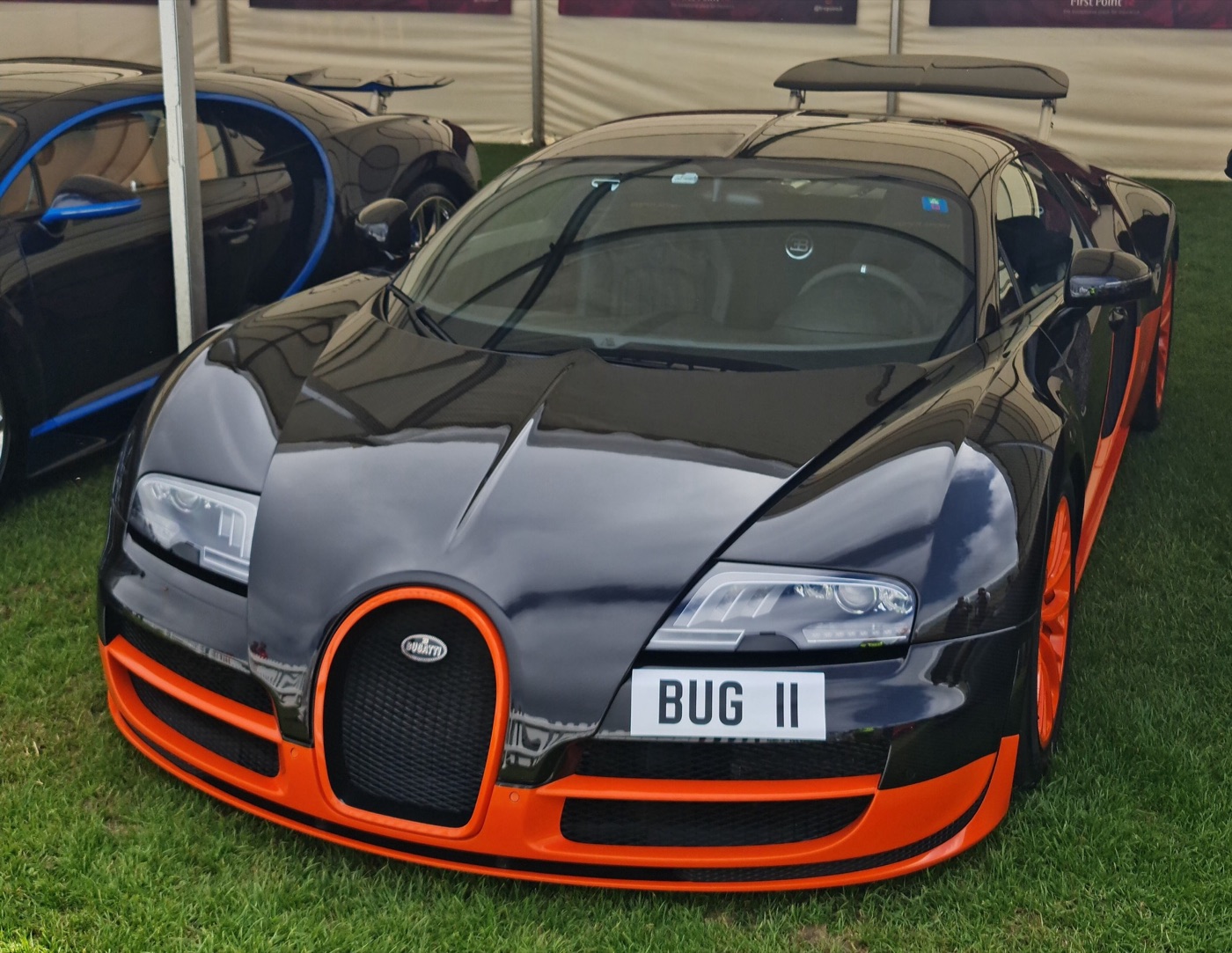 Black and orange Bugatti Veyron Super Sport World Record Edition seen head-on, with an orange horseshoe grille and orange lower bodywork