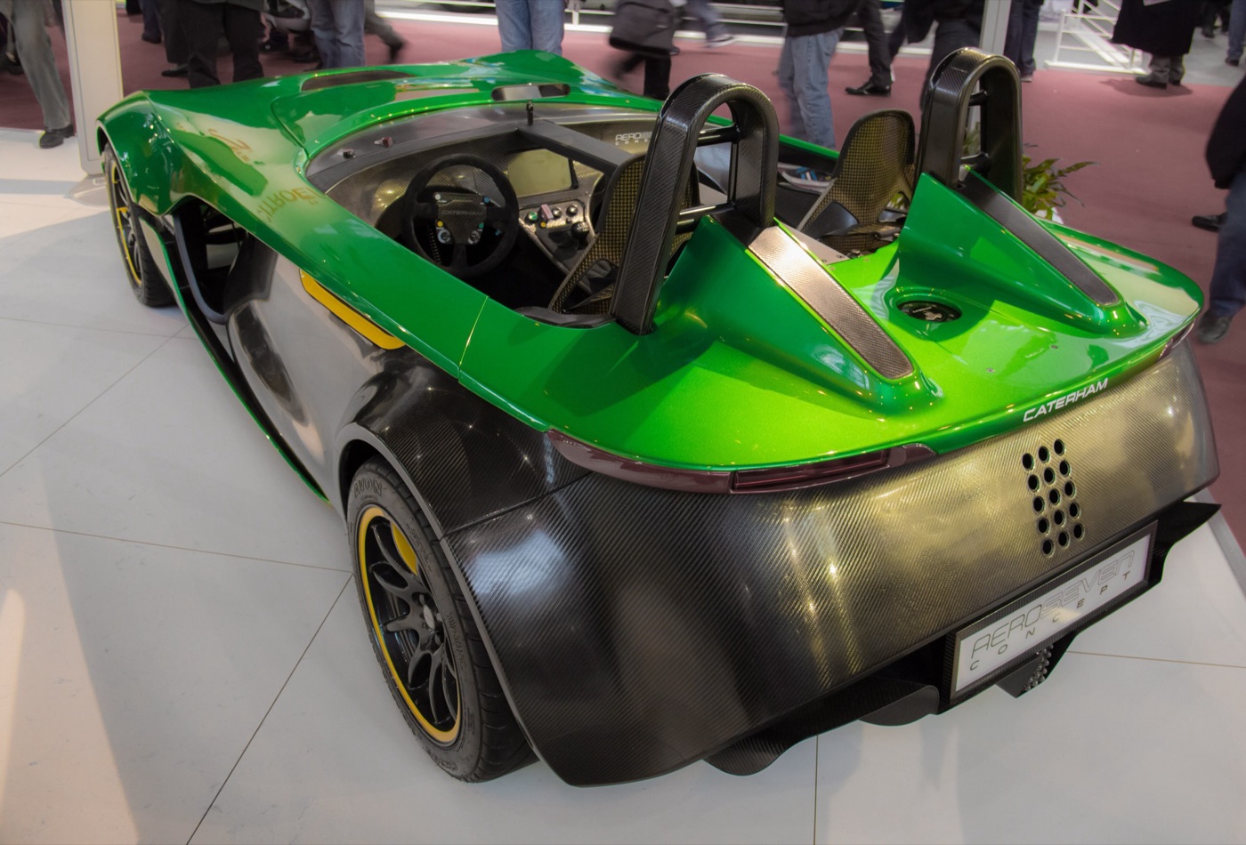 Green and bare carbon-fibre Caterham AeroSeven concept seen from the rear three-quarter, showing its twin roll hoops