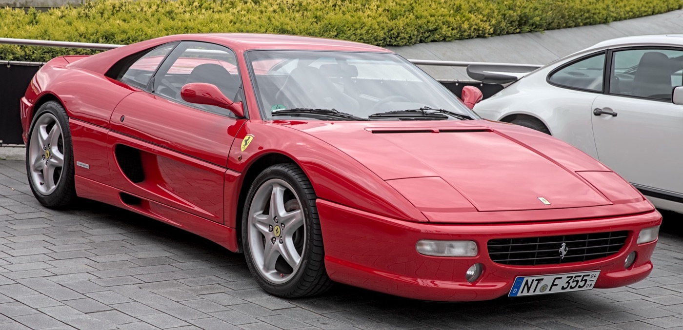 Red Ferrari F355 Berlinetta with pop-up headlamps and side air intakes, registration NT F 355