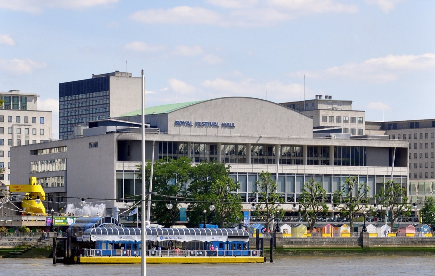 The Royal Festival Hall on London’s South Bank seen across the Thames, with a moored boat in front