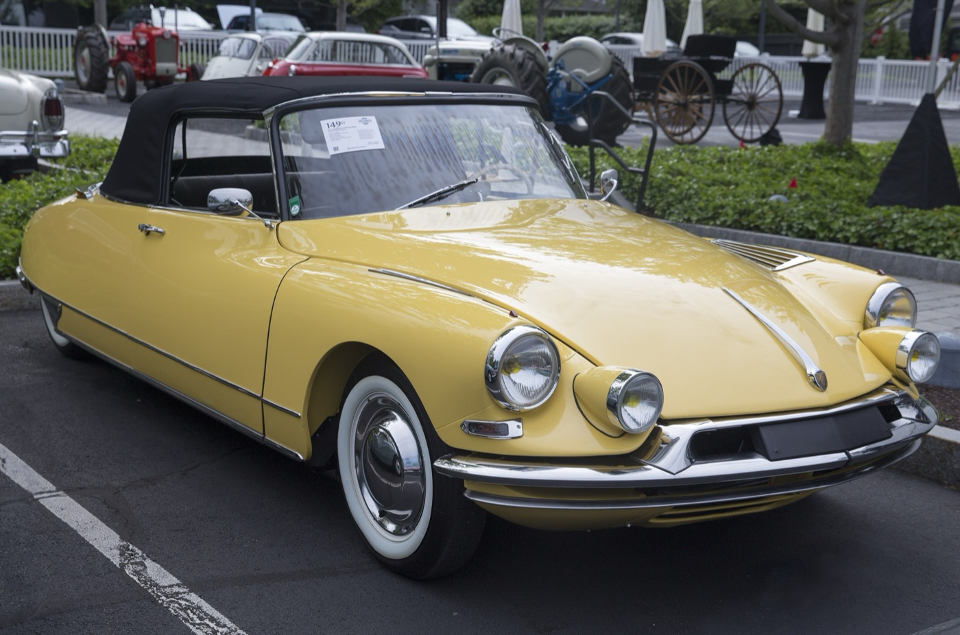 Yellow 1962 Citroën DS 19 Décapotable by Henri Chapron with a black hood, auxiliary headlamps and whitewall tyres