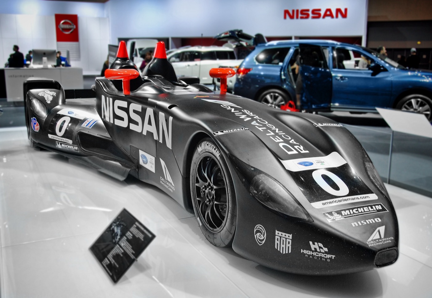 Black DeltaWing number 0 in Nissan colours seen from the front, showing the two narrow front tyres close together under the nose