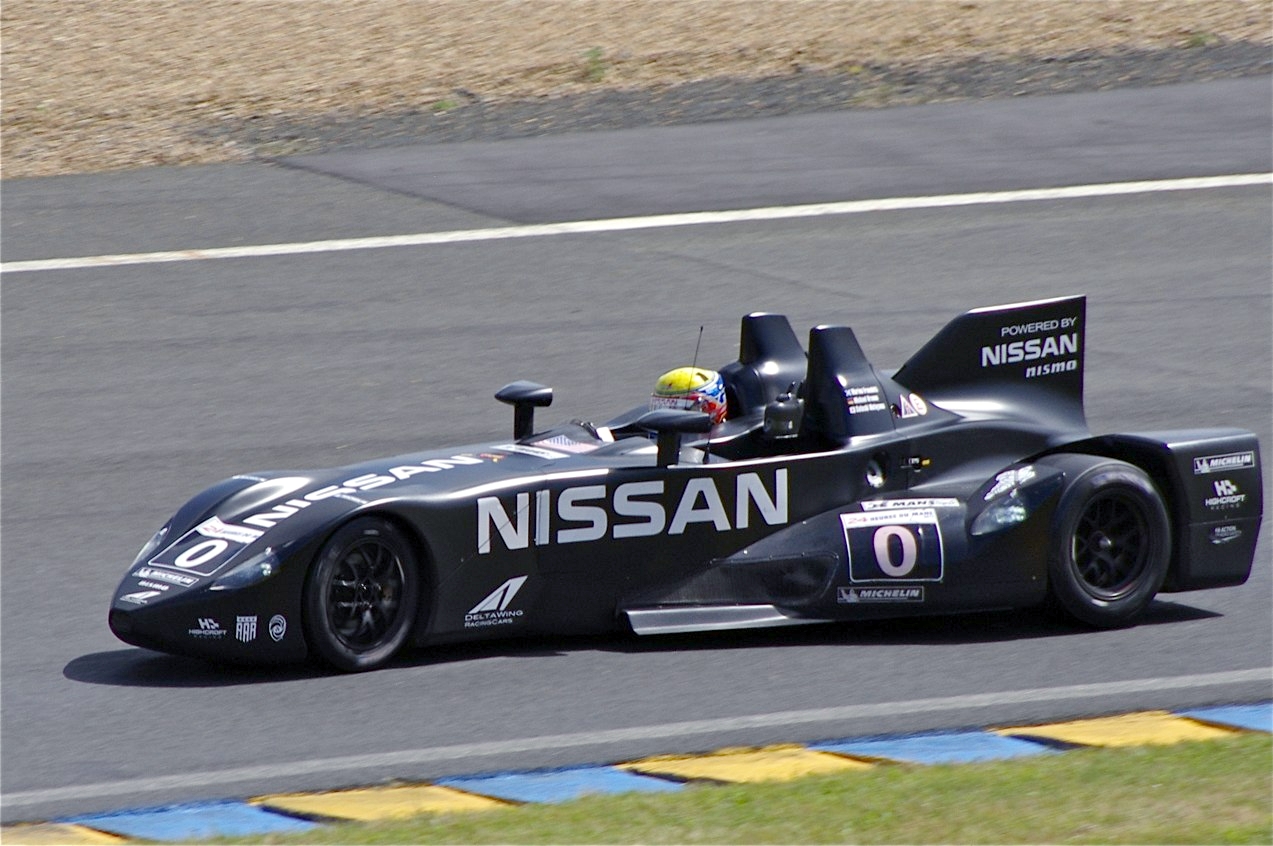 Black Nissan DeltaWing number 0 at speed at Le Mans, showing its long narrow nose and wide rear