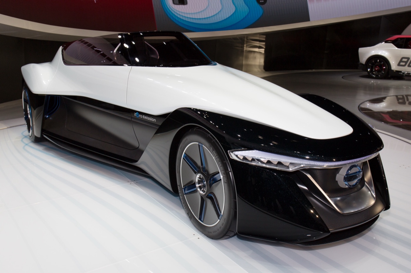 White and black Nissan BladeGlider concept with a narrow front and wide rear on a show stand