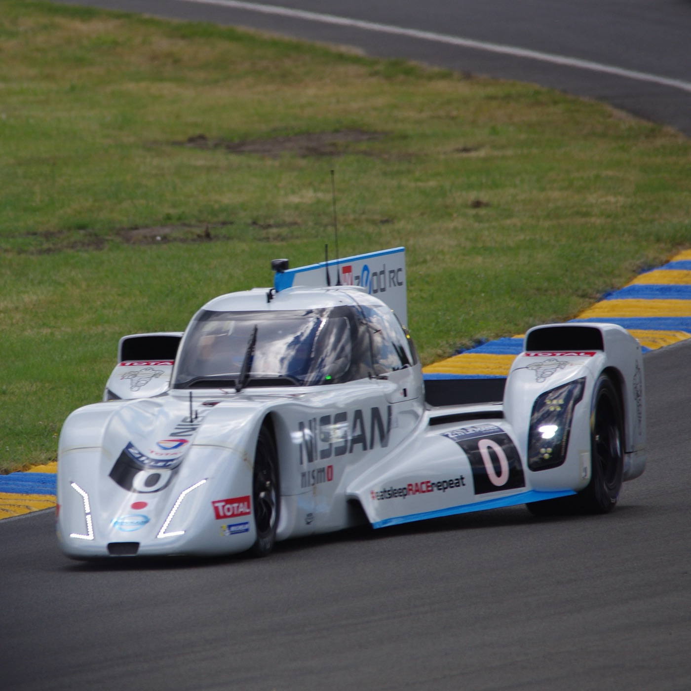 White Nissan ZEOD RC number 0, a closed car with a narrow nose and wide rear, at Le Mans