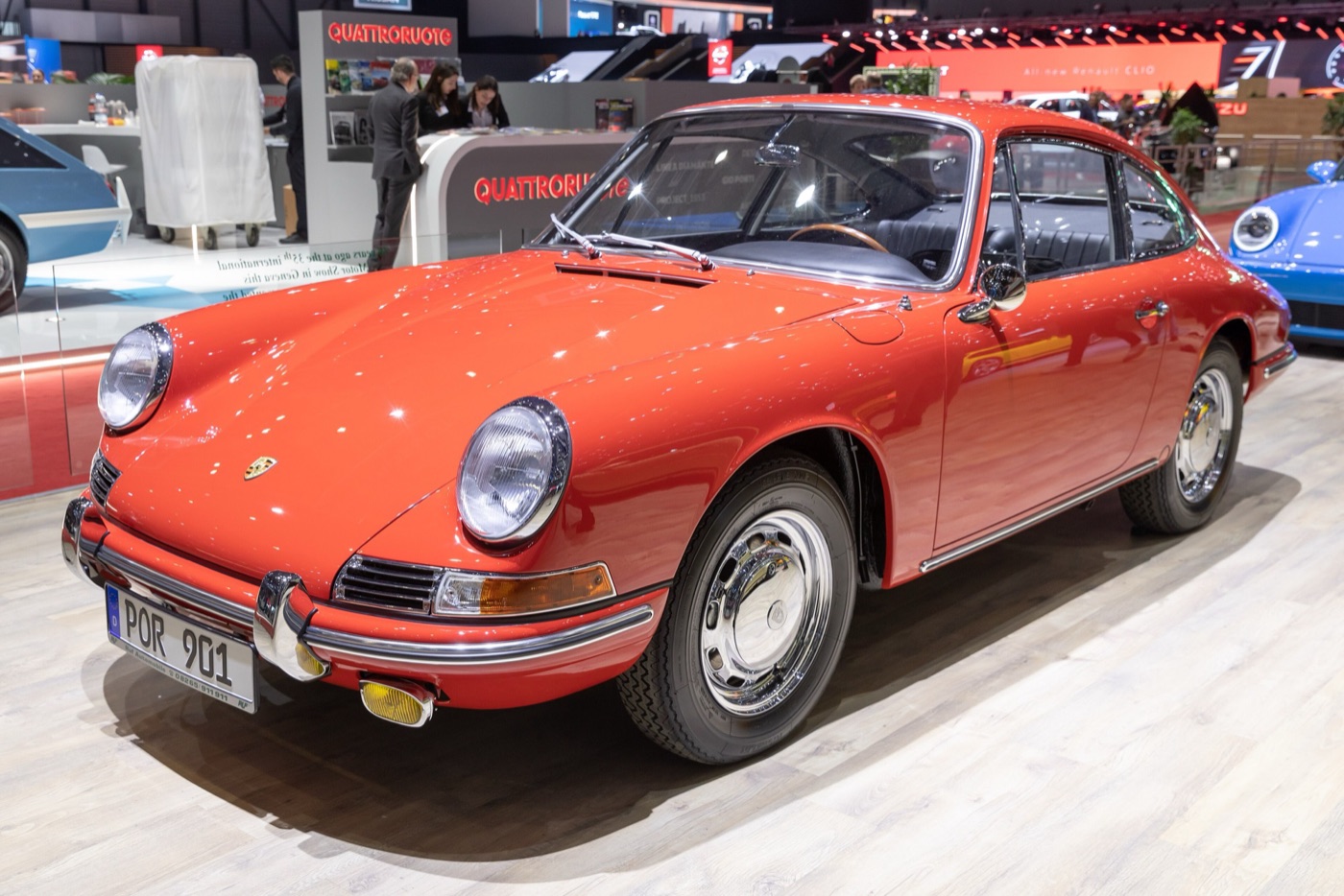 Red Porsche 901, the first 911, seen from the front three-quarter on a motor show stand