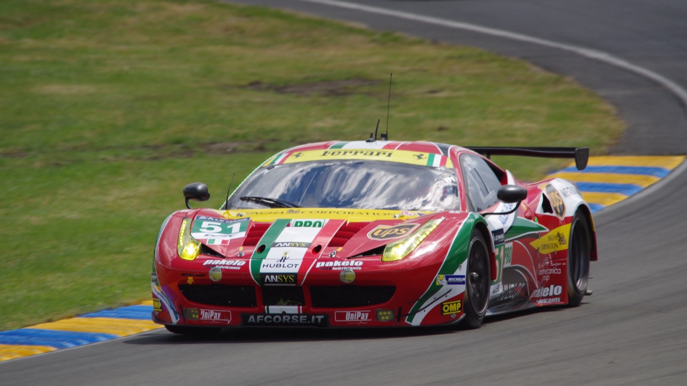 Red, white and green AF Corse Ferrari 458 GTE number 51 cornering at Le Mans