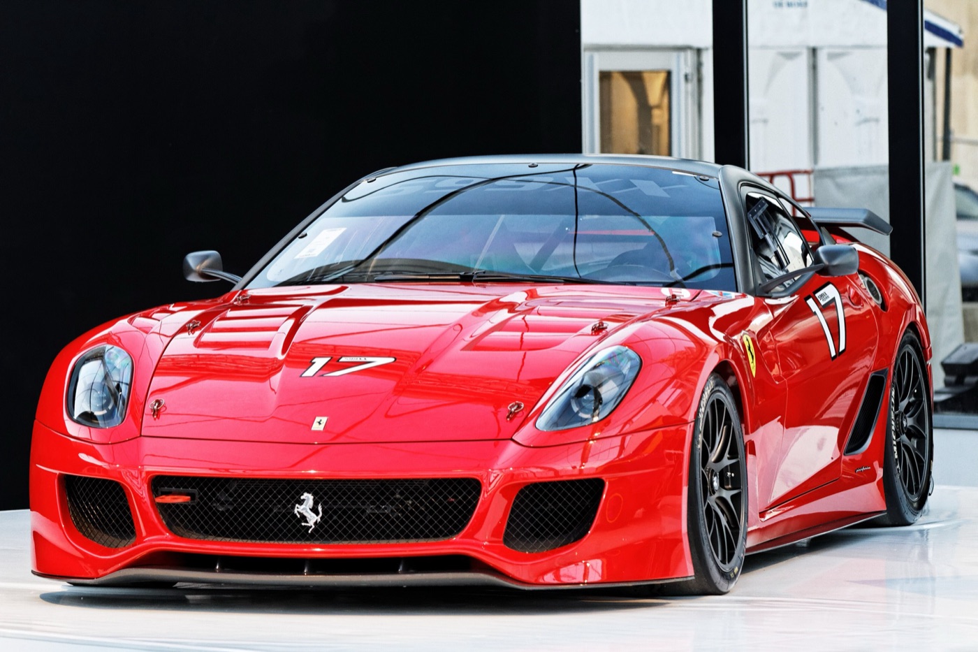Red Ferrari 599XX with race number 17, vented bonnet and black wheels on display