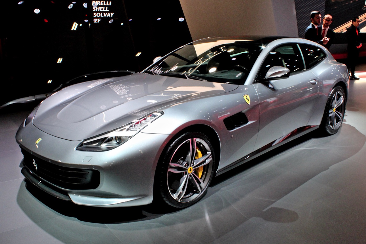 Silver Ferrari GTC4Lusso with yellow brake calipers on a motor show stand