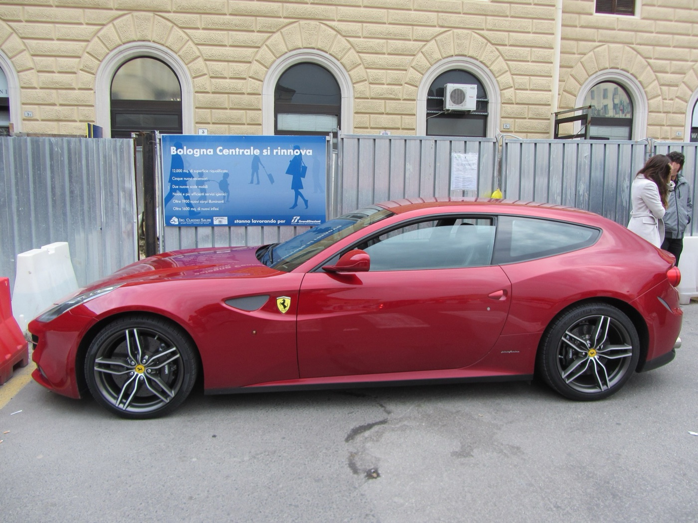 Red Ferrari FF in side profile showing the long bonnet and the shooting brake roof running to the tailgate