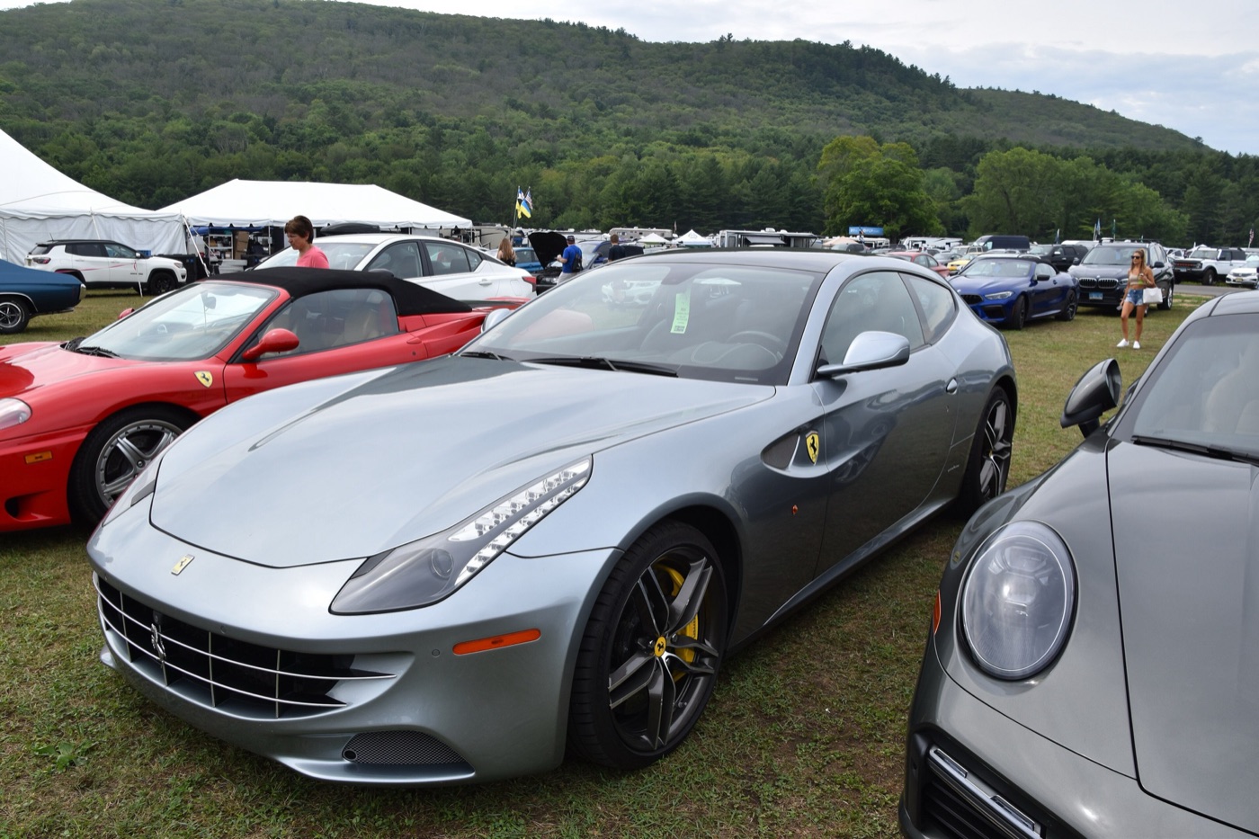 Silver 2015 Ferrari FF with black wheels parked on grass at Lime Rock Park among other cars