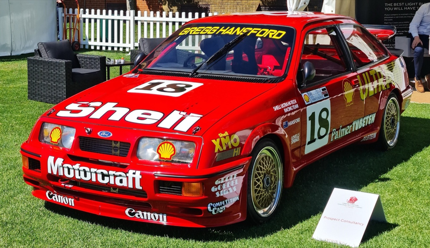 Red Ford Sierra RS500 Group A touring car, number 18, in Shell and Motorcraft livery with Gregg Hansford’s name across the windscreen, displayed on grass