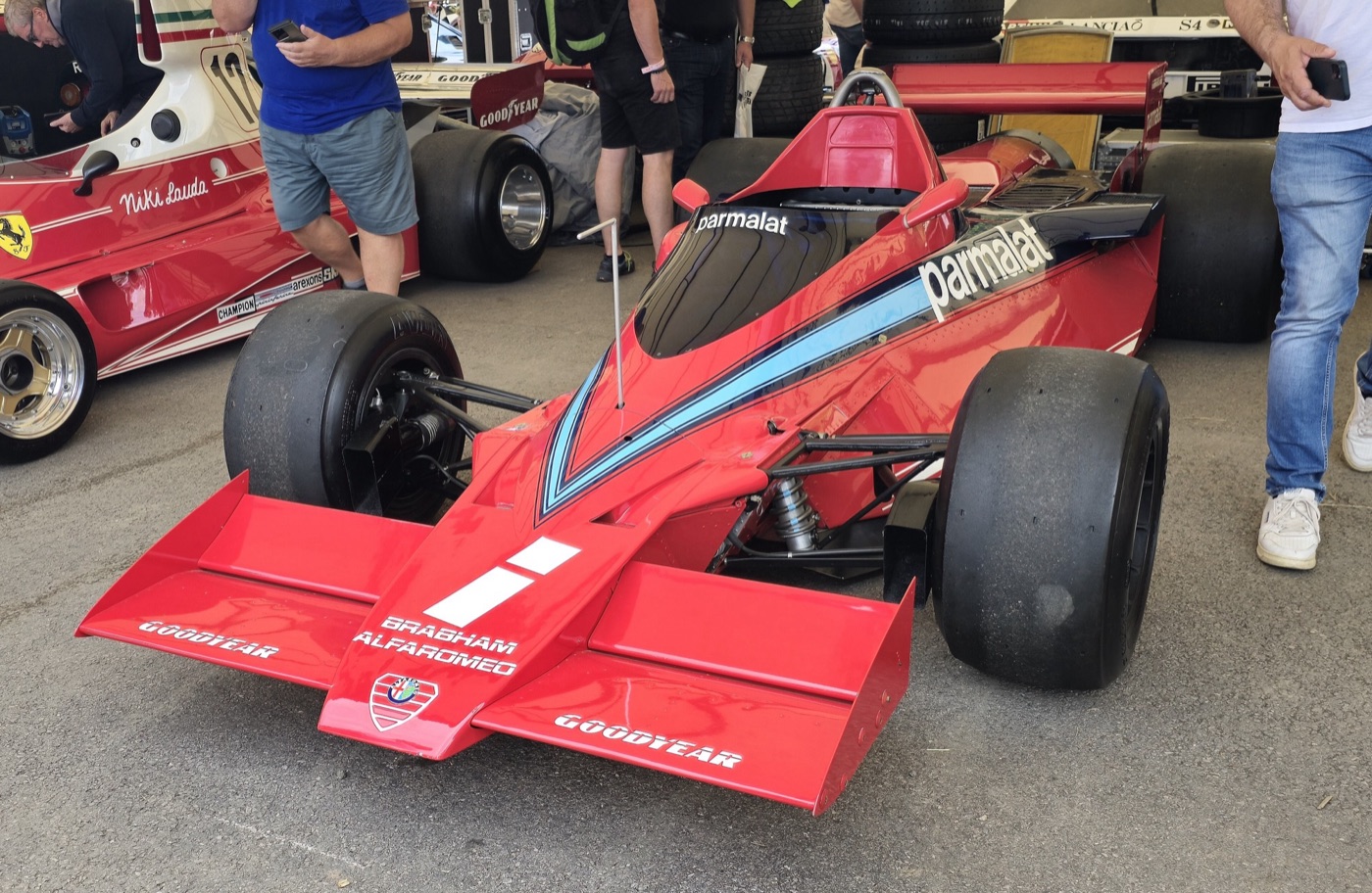 Red Brabham-Alfa Romeo BT46B in Parmalat colours, seen from the front in a paddock garage