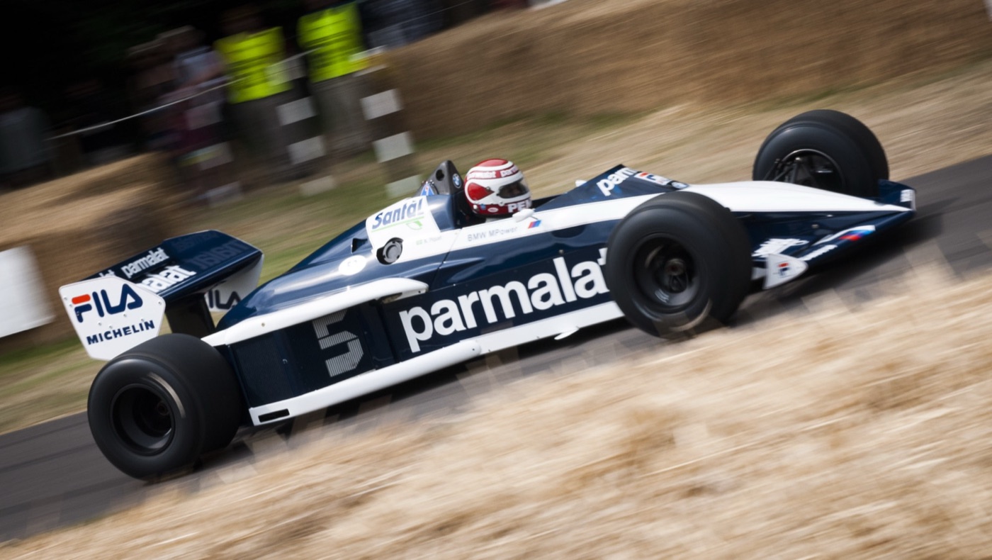 Nelson Piquet driving the blue and white Parmalat Brabham BT52 number 5 past straw bales