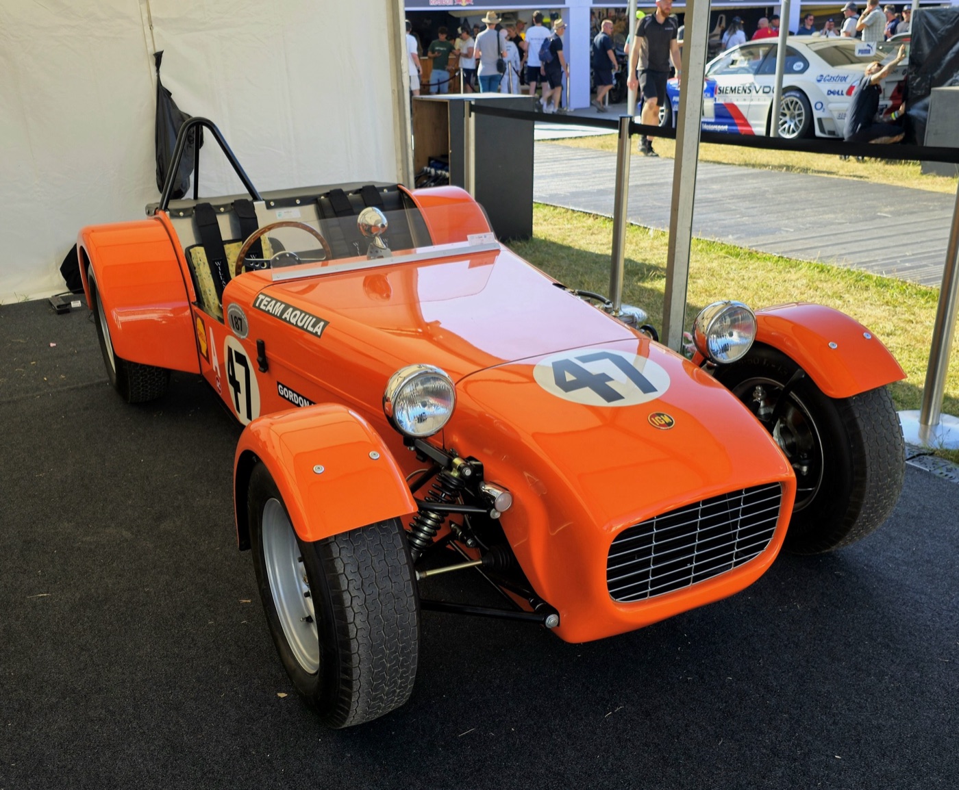 Orange IGM-Ford T1 sports racer with cycle wings, a roll hoop and the race number 47 on its bonnet and side