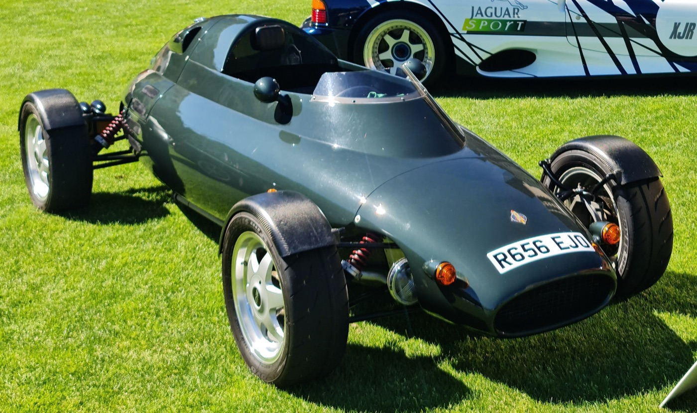 Dark green Light Car Company Rocket single-seater-style roadster with cycle wings, registration R656 EJO, parked on grass