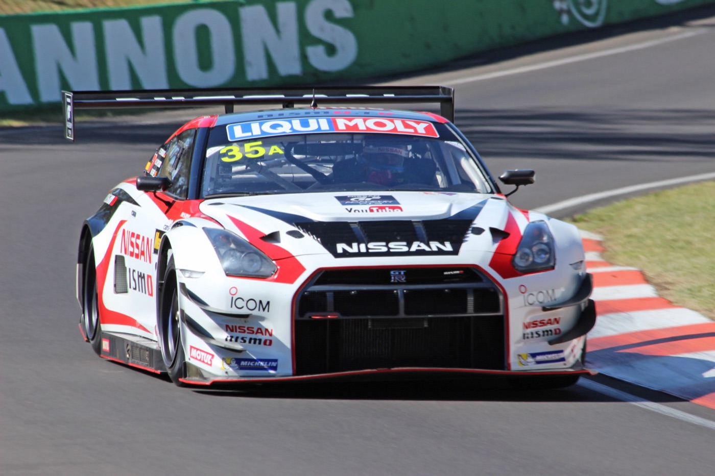 White and red Nissan GT-R Nismo GT3, number 35, with a GT Academy sticker on its bonnet, cornering at Mount Panorama