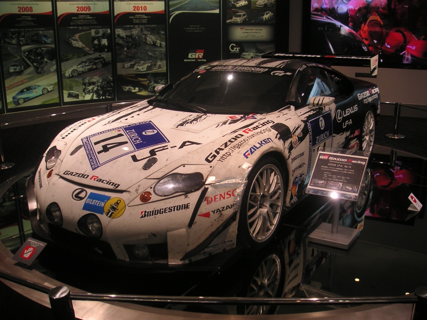 Mud-streaked white and black Lexus LF-A race car number 14 in Gazoo Racing livery on display