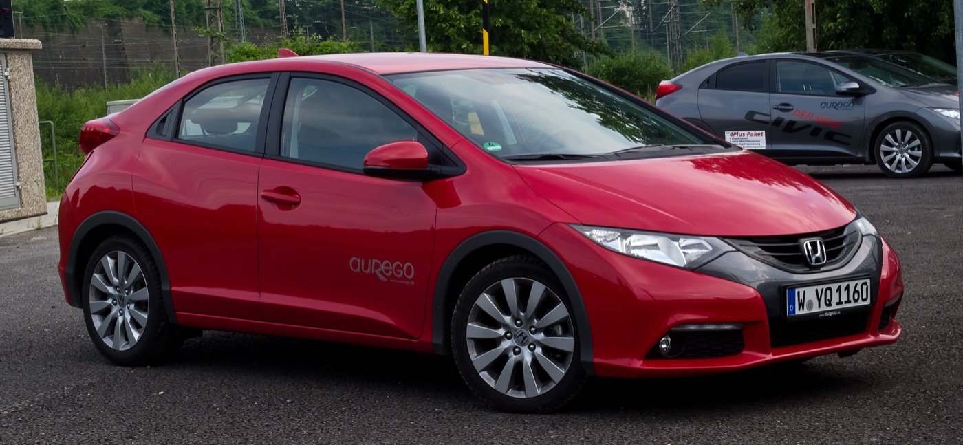 Red 2012 Honda Civic 2.2 i-DTEC Sport hatchback, the European ninth-generation model, parked on tarmac