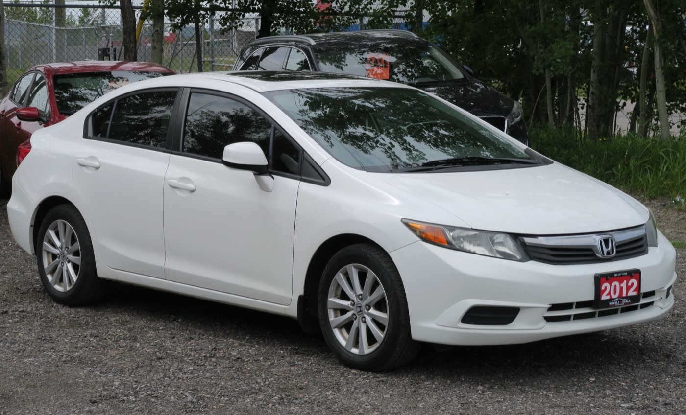 White 2012 Honda Civic EX-L saloon, the North American ninth-generation body, on a dealer forecourt