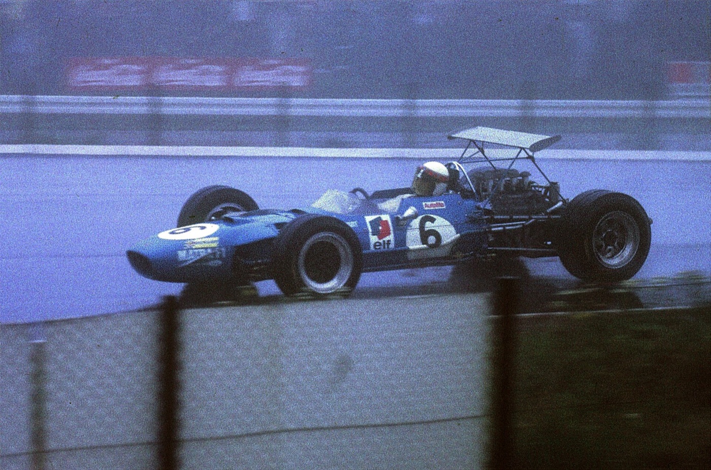 Jackie Stewart in the blue Matra MS10, number 6, on a wet track during the 1968 German Grand Prix at the Nürburgring