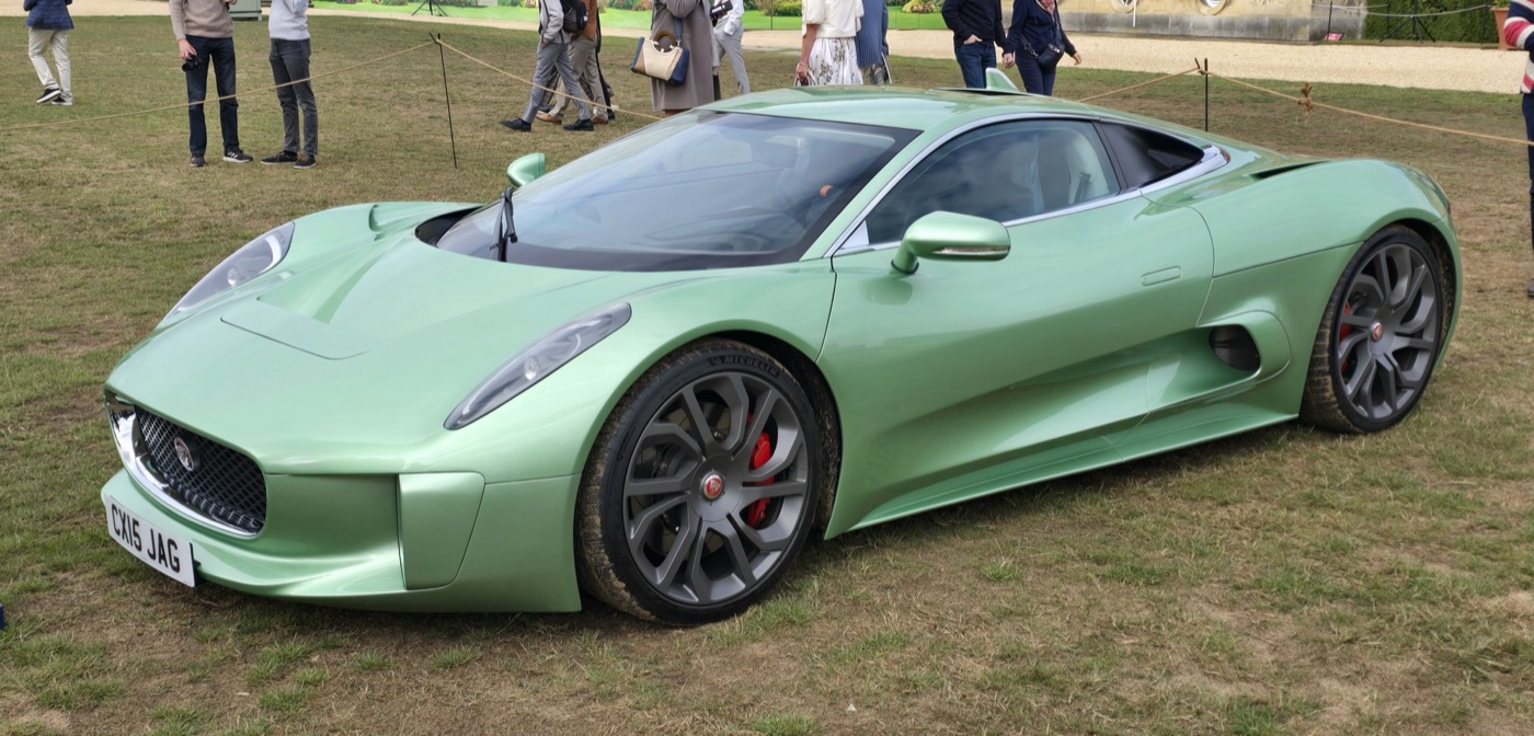 Pale green Jaguar C-X75 with UK number plate CX15 JAG on a lawn at a concours